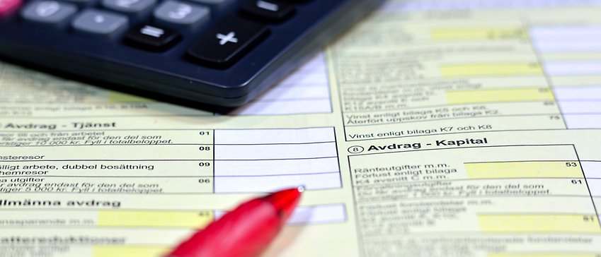 Del av deklarationsblankett, penna och miniräknare